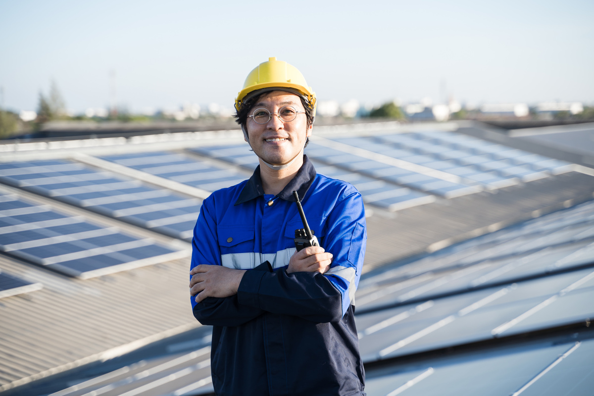 Engineer on Rooftop with Solar Panels